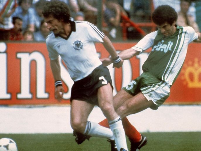 West German defender Paul Breitner (R) tries to control the ball under pressure from Algerian midfiedler Mustapha Dahleb during the World Cup first round soccer match between West Germany and Algeria 16 June 1982 in Gijon. Algeria upset West Germany 2-1. AFP PHOTO