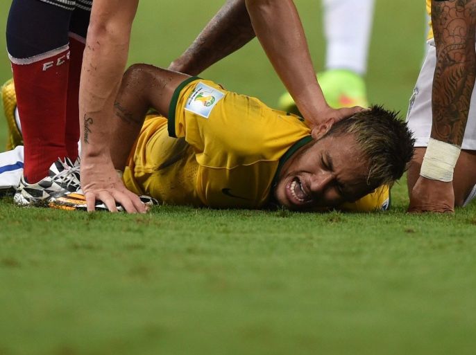 Neymar of Brazil lies on the pitch after picking up an injury during the FIFA World Cup 2014 quarter final match soccer between Brazil and Colombia at the Estadio Castelao in Fortaleza, Brazil, 04 July 2014. (RESTRICTIONS APPLY: Editorial Use Only, not used in association with any commercial entity - Images must not be used in any form of alert service or push service of any kind including via mobile alert services, downloads to mobile devices or MMS messaging - Images must appear as still images and must not emulate match action video footage - No alteration is made to, and no text or image is superimposed over, any published image which: (a) intentionally obscures or removes a sponsor identification image; or (b) adds or overlays the commercial identification of any third party which is not officially associated with the FIFA World Cup) EPA/Marius Becker