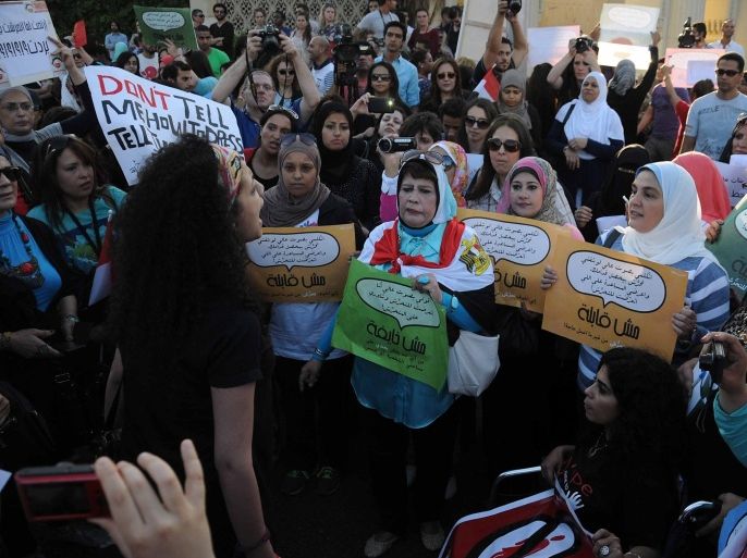Egyptians chant slogans and hold banners during a protest against sexual harassment in Cairo, Egypt, 14 June 2014. At least five cases of sexual assault were reported on 08 June while thousands were celebrating al-Sissi's inauguration in central Cairo's Tahrir Square. A law stipulating harsher punishments for sexual harassment - including between six months and five years in prison was passed last week after a graphic video of a naked woman circulated online. EPA/NAMEER GALAL/ALMASRY ALYOUM EGYPT OUT