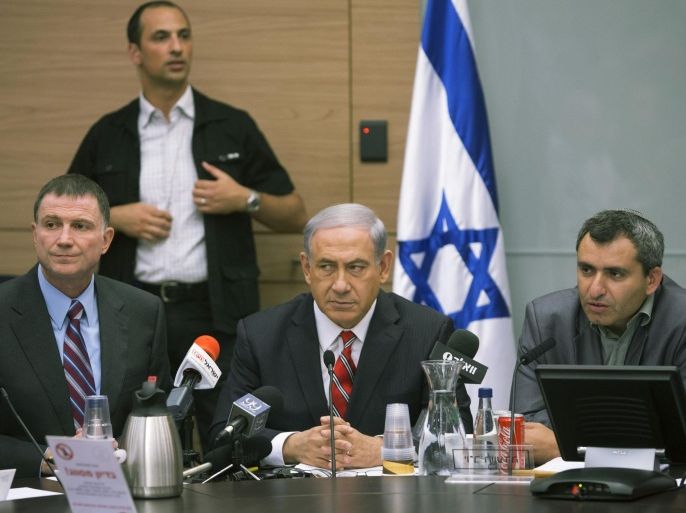 Israeli Prime Minister Benjamin Netanyahu, center, sits with Israeli Deputy Foreign Minister Zeev Elkin, right and Israeli Knesset Speaker Yuli Edelstein during a Foreign Affairs Committee meeting, at the Knesset, Israel's parliament in Jerusalem, Monday, June 30, 2014. At least 14 rockets launched from the Gaza Strip landed in southern Israel early Monday, the Israeli army said, the latest in an intensifying barrage from the Palestinian territory. (AP Photo/Sebastian Scheiner)