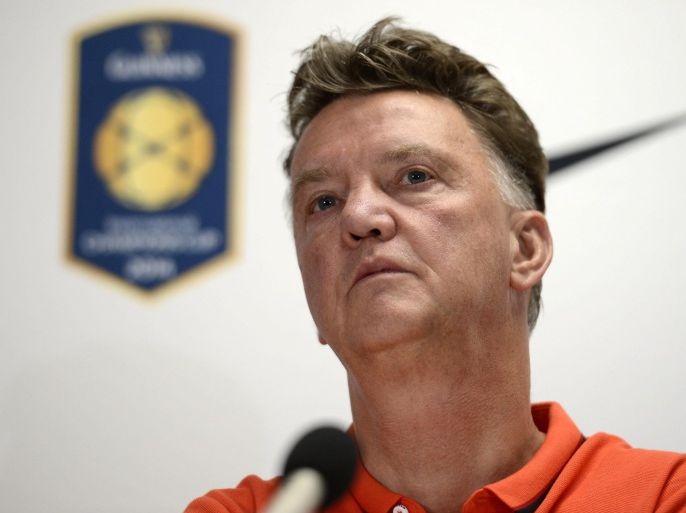 Manchester United head coach Louis van Gaal (L), with defender Chris Smalling (R), responds to a question during a press conference after team training at FedEx Field in Landover, Maryland, USA, 28 July 2014. Manchester United will face Inter Milan on 29 July in match six of the International Champions Cup.