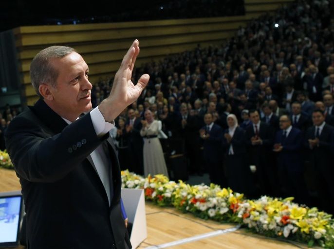 Turkey's Prime Minister Recep Tayyip Erdogan salutes his ruling party members before he has announced he is running for president in Ankara, Turkey, Tuesday, July 1, 2014. After more than a decade in power, Erdogan dominates Turkish politics like a one-man-show. He has defanged the once supreme military, reshaped the judiciary and cowed the press. Now, at the peak of his power, he has announced he is running for president — a role he intends to shape into the most powerful job in Turkey.(AP Photo/Umit Bektas, Pool)