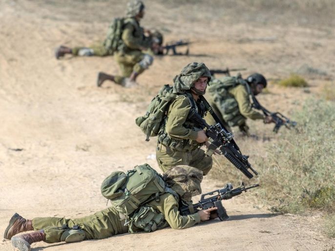 Israeli soldiers hold positions at an army deployment near the Israeli-Gaza border on July 21, 2014, after militants from Gaza infiltrated southern Israel through two tunnels. More than 10 militants from Gaza who accessed Israel were shot dead the Israeli army's official spokesman said. AFP PHOTO / JACK GUEZ