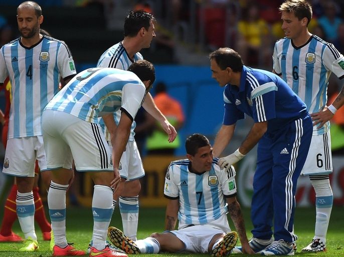 Argentina's midfielder Angel Di Maria (bottom C) is given aid after an injury during a quarter-final football match between Argentina and Belgium at the Mane Garrincha National Stadium in Brasilia during the 2014 FIFA World Cup on July 5, 2014. AFP PHOTO / CHRISTOPHE SIMON