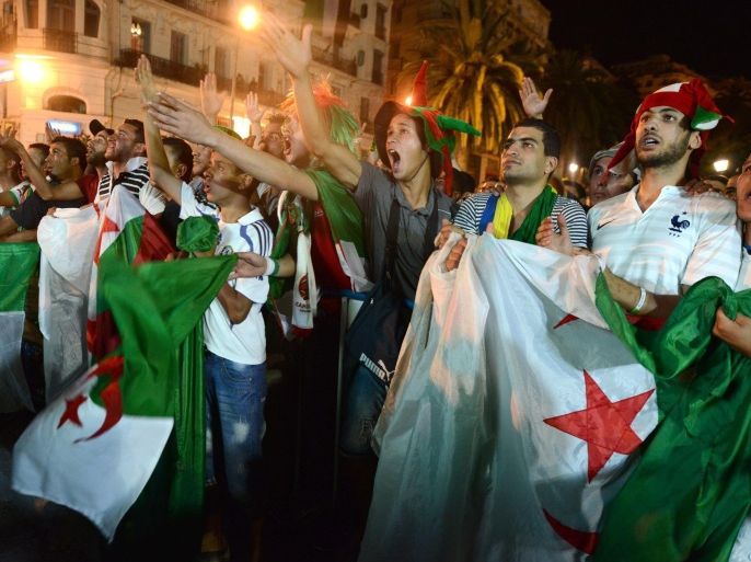 In this photo dated Monday, June 30, 2014, Algerian fans react as they watch the Brazil World Cup round of 16 soccer match between Germany and Algeria in Algiers, Algeria. Germany won 2-1 in extra time. Nigeria and Algeria made World Cup history for Africa and now leave with their heads held high. Despite tenacious resistance, Africa's last representatives were sent home on Monday by France and Germany. (AP Photo/Sidali Djarboud)