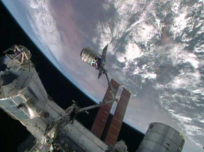 The International Space Station's robotic arm, Canadarm2, grapples the Orbital Sciences' Cygnus cargo craft, as seen in this still image taken from NASA TV July 16, 2014. The Orbital Sciences Corp cargo ship reached the International Space Station on Wednesday with a delivery of food, supplies, science experiments and a fleet of tiny Earth-imaging satellites that will be launched from the orbital outpost. REUTERS/NASA TV/Handout via Reuters (OUTER SPACE - Tags: SCIENCE TECHNOLOGY) ATTENTION EDITORS � THIS PICTURE WAS PROVIDED BY A THIRD PARTY. REUTERS IS UNABLE TO INDEPENDENTLY VERIFY THE AUTHENTICITY, CONTENT, LOCATION OR DATE OF THIS IMAGE. FOR EDITORIAL USE ONLY. NOT FOR SALE FOR MARKETING OR ADVERTISING CAMPAIGNS. THIS PICTURE IS DISTRIBUTED EXACTLY AS RECEIVED BY REUTERS, AS A SERVICE TO CLIENTS