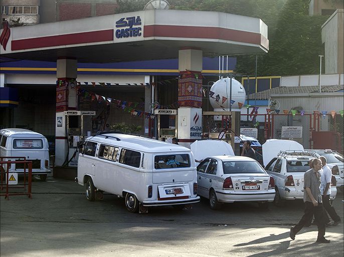 Egyptians gather at a petrol station on July 5, 2014 in Cairo as the government drastically raised fuel prices to tackle a bloated subsidy system. The government raised the price of 92 octane gasoline, which sold at 1.85 pounds ($0.36) a litre, to 2.6 pounds, and 80 octane gas from 0.9 pounds to 1.6 pounds a litre, in a potentially unpopular move that might blow back on newly elected President Abdel Fattah al-Sisi. AFP PHOTO / MAHMOUD KHALED