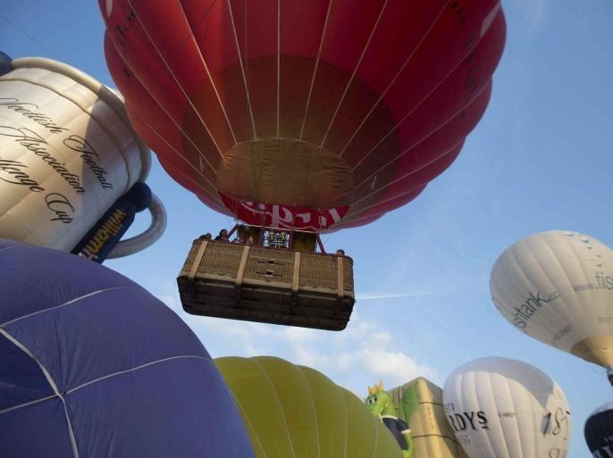 Balloons rise into the sky at the International Balloon Fiesta near Bristol in western England August 8, 2014. REUTERS/Neil Hall (BRITAIN - Tags: SOCIETY)