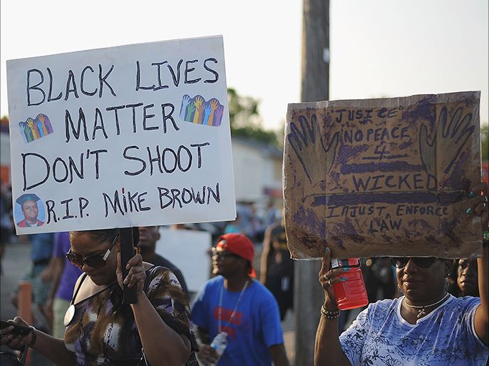 St. Louis, Missouri, UNITED STATES : Protestors walk during a peaceful protest on West Florissant Ave. in Ferguson, Missouri on August 19, 2014. Police in the US city of St. Louis shot dead another suspect on Tuesday, a short distance from a suburb that is the scene of protests over the killing of an unarmed black teenager. St. Louis Police Chief Sam Dotson said in a tweet that officers had responded to a call and found an apparently agitated man, armed with a knife who yelled "kill me now" and approached the patrol. AFP PHOTO / Michael B. THOMAS