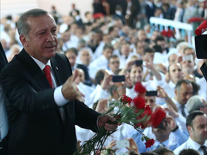 Turkish president-elect Recep Tayyip Erdogan greet the audience upon his arrival at the AK Party Extraordinary Congress in Ankara,on August 27, 2014. AFP PHOTO/ADEM ALTAN