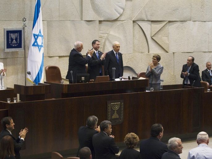 Newly sworn-in Israeli President Reuven Rivlin, top row, from second left, and Parliament Speaker Yuli Edelstein applaud outgoing President Shimon Peres as other parliament members also join them during a ceremony at the Knesset, Israel's parliament, in Jerusalem on Thursday, July 24, 2014. Israel's lawmakers on Thursday swore in Rivlin from the hard-line Likud party as the country's new president, replacing Nobel Peace laureate Peres, who had promoted peace throughout his long political career but whose term ended as Israel is fighting a war against Hamas in Gaza. (AP Photo/Ronen Zvulun, Pool)
