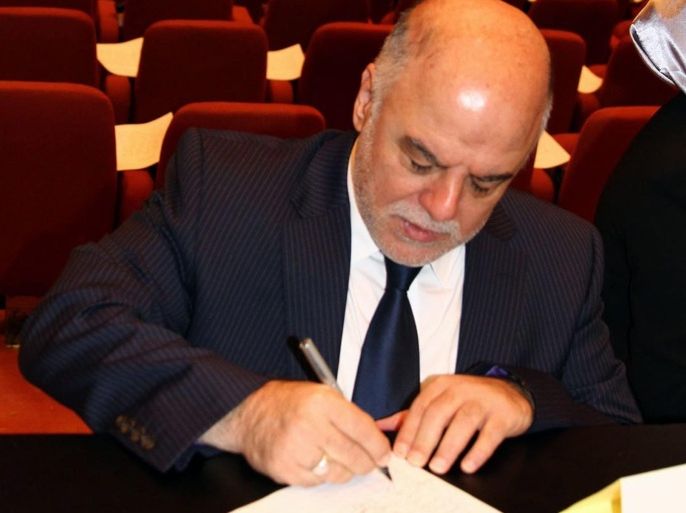 (FILE) A file picture dated 01 July 2014, showing Iraqi lawmaker Haider al-Abadi, the new Candidate for the position of Iraqi prime minister signing a document during the Iraqi parliament session in Baghdad. The Iraq's main Shiite parliamentary alliance nominates Haider al-Abadi to replace Nuri al-Maliki as prime minister, local media report on 11 August 2014.