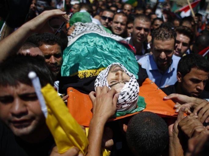 ATTENTION EDITORS - VISUAL COVERAGE OF SCENES OF INJURY OR DEATH Mourners carry the body of Palestinian Oday Jaber, whom medics said was killed by Israeli troops during clashes at a protest against the Israeli offensive in Gaza on Friday, during his funeral in the West Bank village of Rafat near Ramallah August 2, 2014. Israeli forces killed two Palestinians in clashes in the occupied West Bank on Friday, Palestinian medical officials said. The violence erupted when a few thousand Palestinians took to the street to protest Israel's military operation in the Gaza Strip. Both men were killed by live fire in two separate incidents, Palestinian medical officials said. An Israeli military spokeswoman said troops shot one man in the city of Tulkarm after violence got out of control, with protesters throwing stones and gasoline bombs at soldiers. In the second incident near the city of Ramallah, the spokeswoman said troops resorted to using live fire after protesters were not deterred by riot-dispersal means that troops had deployed initially. REUTERS/Mohamad Torokman (WEST BANK - Tags: POLITICS CIVIL UNREST) TEMPLATE OUT