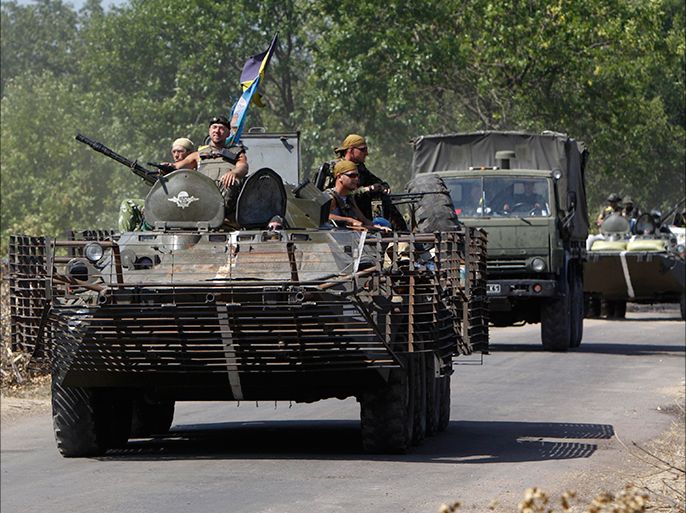 A Ukrainian military convoy moves along a road near Donetsk August 9, 2014. Ukraine said on Saturday it had headed off an attempt by Russia to send troops into Ukraine under the guise of peacekeepers with the aim of provoking a large-scale military conflict, a statement Moscow dismissed as a "fairy tale". REUTERS/Valentyn Ogirenko (UKRAINE - Tags: POLITICS CIVIL UNREST MILITARY)