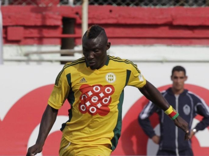 JS Kabylie striker Albert Ebosse, from Cameroon, runs with the ball during the Algeria Cup final soccer match against MC Alger in Algiers May 1, 2014. The Confederation of African Football (CAF) have called for "exemplary sanctions" following the death of JS Kabylie striker Albert Ebosse, who was killed by a projectile thrown from the crowd in an Algerian league match on Saturday. Picture taken May 1, 2014. REUTERS/LOUAFI LARBI ( ALGERIA - Tags: SPORT SOCCER)