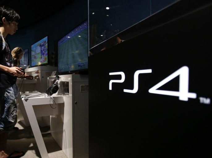 A man plays a video game on Sony Corp's PlayStation 4 console at its showroom in Tokyo July 16, 2014. Japan's Sony Corp is hammering out plans to rise from the ashes of nearly $10 billion lost in six years by building a future around its last consumer electronics blockbuster - the PlayStation. Sony plans to reposition the video console warhorse as a hub for a network of streamed services, according to three senior officials, offering social media, movies and music as well as games. The executives spoke to Reuters on condition they not be named because the matters are still in early stages of discussion. Picture taken July 16, 2014. REUTERS/Yuya Shino (JAPAN - Tags: BUSINESS)