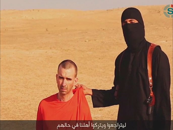 REUTERS IS UNABLE TO INDEPENDENTLY VERIFY THE AUTHENTICITY OF THIS VIDEO A video purportedly showing threats being made to a man Islamic State (IS) named as David Haines by a masked IS fighter in an unknown location in this still image from video released by Islamic State September 2, 2014. The masked figure in the video issued a threat against Haines, and warned governments to back off "this evil alliance of America against the Islamic State", the SITE monitoring service said. REUTERS/Islamic State via Reuters TV (Tags: CRIME LAW CIVIL UNREST)ATTENTION EDITORS - THIS PICTURE WAS PROVIDED BY A THIRD PARTY. REUTERS IS UNABLE TO INDEPENDENTLY VERIFY THE AUTHENTICITY, CONTENT, LOCATION OR DATE OF THIS IMAGE. NO SALES. NO ARCHIVES. FOR EDITORIAL USE ONLY. NOT FOR SALE FOR MARKETING OR ADVERTISING CAMPAIGNS. IT IS DISTRIBUTED, EXACTLY AS RECEIVED BY REUTERS, AS A SERVICE TO CLIENTS