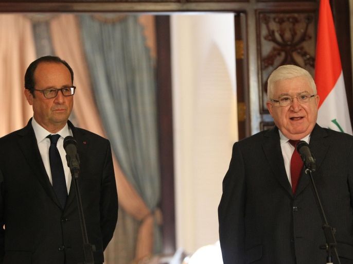 French President Francois Hollande listens to his Iraqi counterpart Fuad Masum (R) during a joint news conference following their meeting in Baghdad on September 12, 2014. Hollande extended his country's 'support and solidarity' to Iraq's new government as he began a one-day visit to the war-torn country as part of international efforts to defeat jihadist fighters. AFP Photo/ ALI AL-SAADI