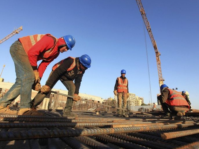 Labourers work at the construction site of Al-Mokhtar tower project in Benghazi January 19, 2013. Unlike the capital Tripoli, Benghazi, Libya's second-biggest city, has few modern high-rise developments. The development of many construction projects is being promoted as Benghazi bids to regain its former status as the country's business capital and end what local residents see as decades of marginalisation. Picture taken January 19, 2013. To match Mideast Money LIBYA-BENGHAZI/ REUTERS/Esam Al-Fetori (LIBYA - Tags: REAL ESTATE BUSINESS POLITICS CONSTRUCTION)