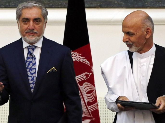 Afghan rival presidential candidates Abdullah Abdullah (L) and Ashraf Ghani stand together after exchanging signed agreements for the country's unity government in Kabul September 21, 2014. Abdullah and Ghani signed a deal to share power in the unity government on Sunday, capping months of turmoil over a disputed election that destabilised the nation at a crucial time as foreign troops prepare to leave. Ashraf Ghani, a former finance minister, will be named president under the deal reached on Saturday night. REUTERS/Omar Sobhani (AFGHANISTAN - Tags: POLITICS ELECTIONS)