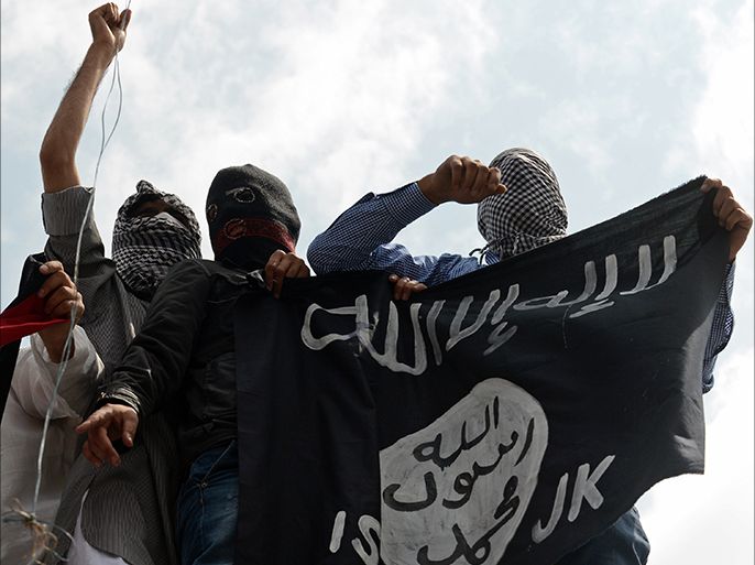 (FILES) In this photogaph taken on July 18, 2014, Kashmiri demonstrators hold up a flag of the Islamic State of Iraq and the Levant (ISIL) during a demonstration against Israeli military operations in Gaza, in downtown Srinagar. Al-Qaeda launched a new branch to "wage jihad" in South Asia as it sought September 4, 2014 to invigorate its waning Islamist extremist movement, but experts said it would struggle to gain traction with India's Muslims. Al-Qaeda once attracted jihadists from around the world to training camps on the Afghan-Pakistan border, but has seen its global influence eclipsed by the Islamic State (IS) jihadist group fighting in Iraq and Syria. AFP PHOTO/Tauseef MUSTAFA/FILES