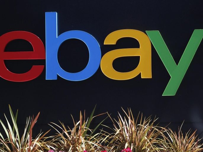 An eBay sign is seen at an office building in San Jose, California in this file photo taken May 28, 2014. EBay Inc said it would spin off PayPal, its fast-growing payments business, into a publicly traded company in the second half of 2015, marking an about-face for the company. REUTERS/Beck Diefenbach/Files (UNITED STATES - Tags: BUSINESS LOGO)