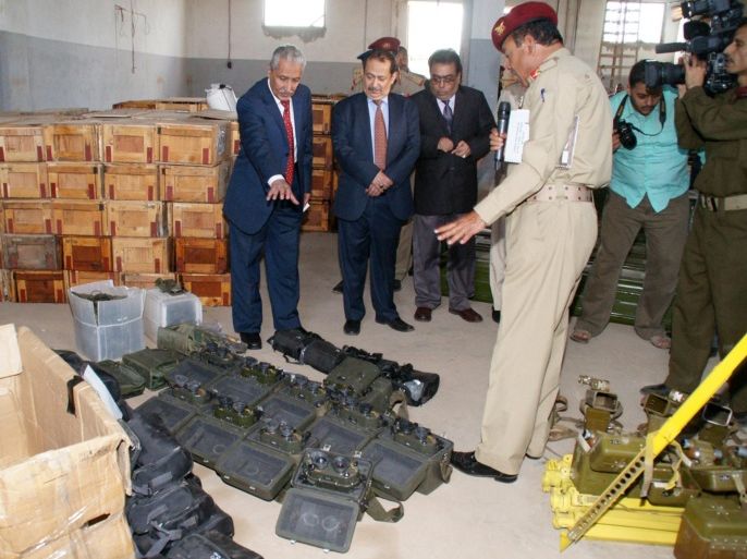 In this photo taken on Saturday, Feb. 2, 2013, released by the Yemeni Defense Ministry, Yemeni Interior Minister Major-General Abdul-Qader Qahtan, left, and Chief of the National Security Agency Major-General Ali al-Ahmadi, second left, inspect weapons unloaded from an Iranian ship in Aden, Yemen. The president of Yemen has sent a message to his Iranian counterpart calling on him to stop sending arms to Yemen and quit supporting the southern separatist movement.