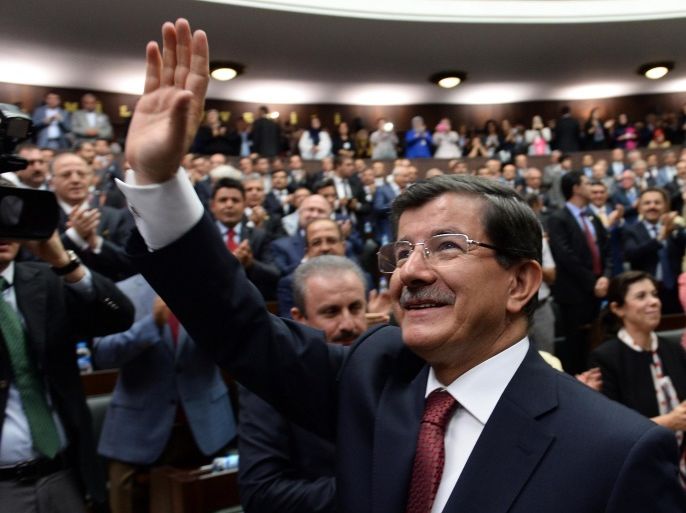 Turkey's Prime Minister Ahmet Davutoglu greets members of the parliament from his ruling AK Party (AKP) during a meeting at the Turkish parliament in Ankara on September 1, 2014. AFP PHOTO/ADEM ALTAN