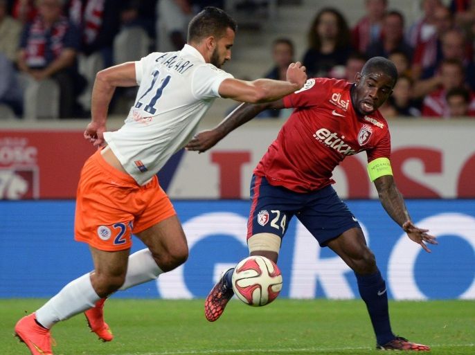 Lille's French midfielder Rio Mavuba (R) vies with Montpellier's French Columbian forward Victor Hugo Montano during the French L1 football match Lille vs Montpellier, on September 21, 2014 at the Lille Grand Stade Pierre Mauroy stadium in Lille, northern France. AFP PHOTO / DENIS CHARLET
