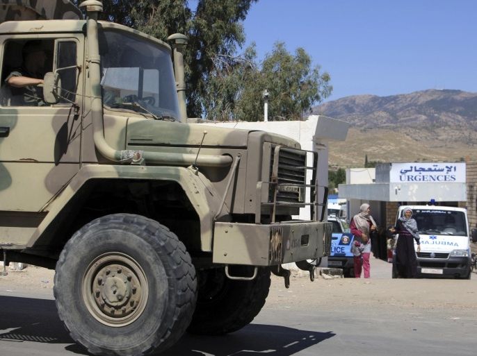 A military truck parks outside the hospital of Kasserine, near the Algerian border, Thursday, July 17, 2014. Militants in western Tunisia staged two simultaneous attacks on army posts while soldiers held a Ramadan feast, killing at least 14 soldiers, authorities said Thursday. (AP Photo/ Mouldi Kraeim)