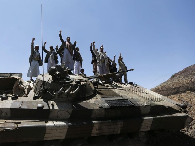 Shi'ite Houthi rebels gesture as they stand atop an army vehicle they took from the compound of the army's First Armoured Division in Sanaa September 22, 2014. Yemen's Shi'ite Muslim rebels signed an agreement with other political parties on Sunday to form a more inclusive government after rebels advanced on major state institutions in the capital Sanaa, largely unopposed by troops and security forces. REUTERS/Khaled Abdullah (YEMEN - Tags: POLITICS CIVIL UNREST MILITARY)