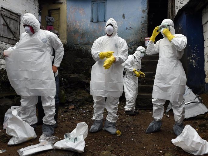 Medical staff members of the Croix Rouge NGO put on protective suits before collecting the corpse of a victim of Ebola, in Monrovia, on September 29, 2014. Of the four west African nations affected by the Ebola outbreak, Liberia has been hit the hardest, with 3,458 people infected -- more than half of the total number of cases. Of those, 1,830 have died, according to a WHO count released on September 27. AFP PHOTO / PASCAL GUYOT