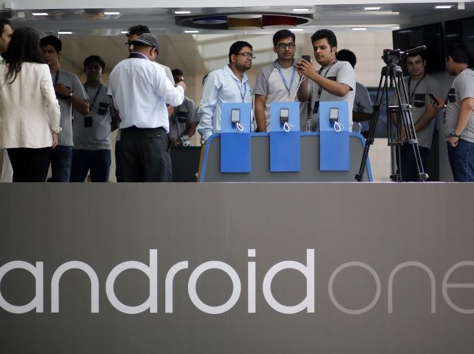 Visitors look at Android One Based mobiles after its launch in New Delhi September 15, 2014. Google Inc launched in India on Monday a $105 smartphone, the first device from its "Android One" initiative which is aimed at boosting sales in key emerging markets through cheaper prices and better quality software. REUTERS/Anindito Mukherjee (INDIA - Tags: SCIENCE TECHNOLOGY BUSINESS TELECOMS)
