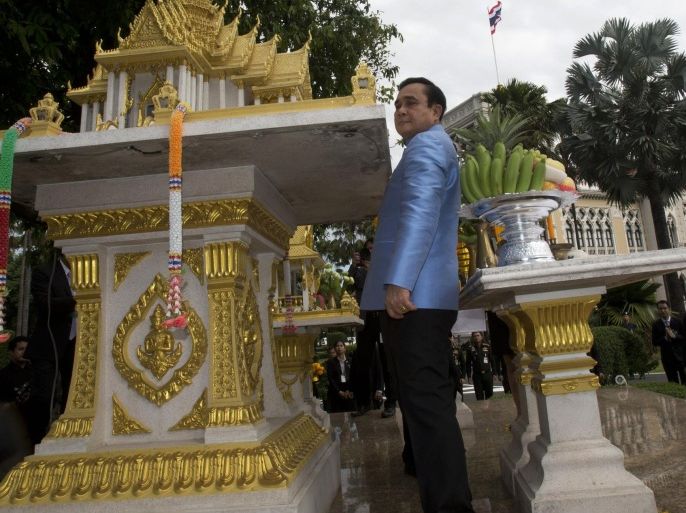 Thailand's Prime Minister Gen. Prayuth Chan-ocha walk between spirit house and table after offering prayer for good luck, before a meeting in the preparation for his cabinet meeting at the Government house in Bangkok, Thailand, Tuesday, Sept. 9, 2014 , Prayuth will deliver his Government's policy statement at Parliament on Friday. (AP Photo/Sakchai Lalit)