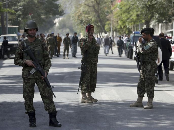Afghanistan's National Army (ANA) soldiers stand guard at the site of an explosion on a road to the presidential palace, in Kabul, Afghanistan, Sunday, Sept. 28, 2014. A military vehicle was detonated by a bomb in diplomatic area in Kabul city. The explosion occurred in the road to the Afghanistan's president palace, a day before the inauguration for the country’s new president. (AP Photo/Rahmat Gul)
