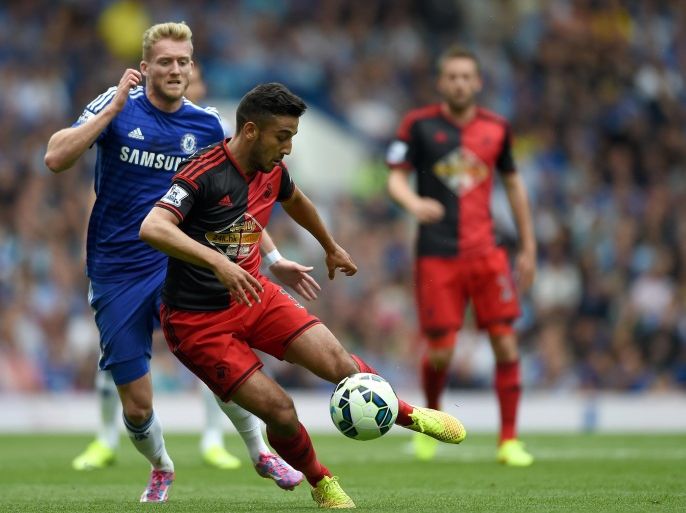 Swansea City’s Neil Taylor, right, and Chelsea’s Andre Schurrle battle for the ball during their English Premier League soccer match at Stamford Bridge, London, Saturday, Sept. 13, 2014. (AP Photo/Tim Ireland)