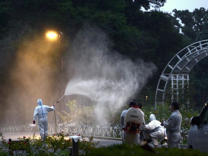 In this Aug. 28, 2014 photo, a worker sprays insecticide to get rid of mosquitos to prevent dengue fever at Yoyogi Park in Tokyo. According to local media reports, Japanese health authorities announced on Thursday they confirmed two more transmitted cases of dengue fever, a day after the authorities have reported the first locally transmitted case of the illness in the country in more than 60 years. They are believed to have been infected after being bitten by mosquitoes at the park. (AP Photo/Kyodo News) JAPAN OUT, MANDATORY CREDIT