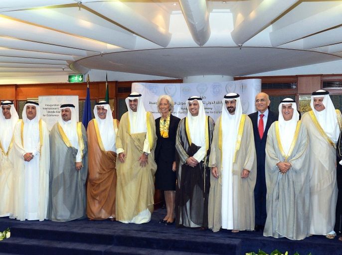 Finance Ministers and Central Banks Governors of the Gulf Cooperation Council (GCC) countries pose with International Monetary Fund (IMF) Managing Director Christine Lagarde (C) during their annual meeting on October 25, 2014 in Kuwait City. Kuwait Oil Minister Anas al-Saleh warned energy-dependent Gulf states that the drop in oil prices has started to impact their finances and called for urgent economic reforms. AFP PHOTO / YASSER AL-ZAYYAT