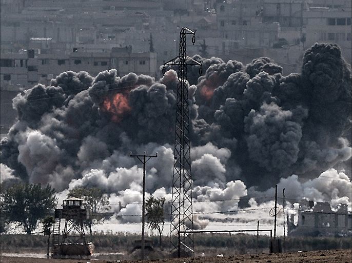 A picture taken from the Turkish border near the southeastern village of Mursitpinar, in the provience of Sanliurfa shows smoke billowing after a jet fighter hit Kobani, also known as Ain al-Arab, on October 28, 2014. Turkey wants the anti-Damascus Free Syrian Army (FSA) to control the Syrian border town of Kobane if Islamist jihadists are defeated, and not the forces of separatist Kurds or President Bashar al-Assad, Prime Minister Ahmet Davutoglu said. Turkey is fearful that Kobane could be taken over by Kurds allied to the Kurdistan Workers' Party (PKK) which has waged a three-decade insurgency for self rule and is regarded as a terrorist group by Turkey, the United States and most of Europe.AFP PHOTO/STRINGER