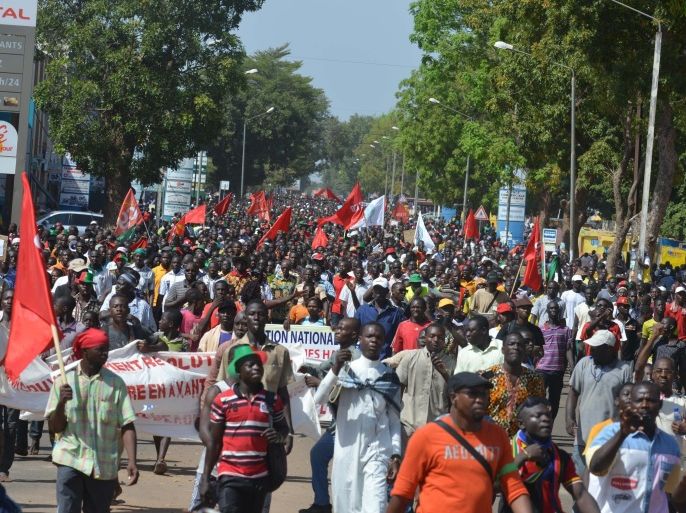 People on October 29, 2014 take part in a march to protest against the cost of living in Ouagadougou. Trade unions in Burkina Faso have called a general strike on Wednesday following a day of protests against long-serving President Blaise Compaore that saw hundreds of thousands of people on the streets. AFP PHOTO / ISSOUF SANOGO
