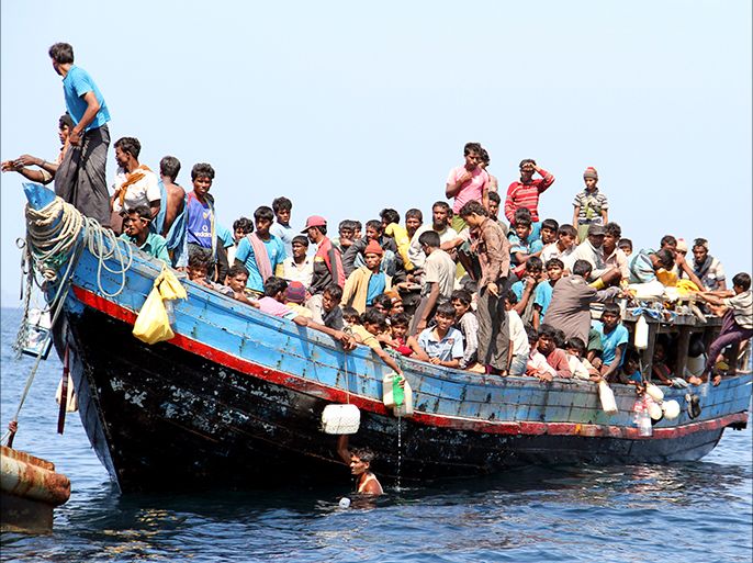 epa03560485 Ethnic Rohingya refugees from Myanmar gather on a boat as they are being rescued by Thai Navy officers before they head to Malaysia, at the Andaman coast, Phuket island, southern Thailand, 29 January 2013. Some 205 of persecuted Rohingya Muslim minority people arrived on a boat in southern Thailand sea coast, on a stopover ahead of their Malaysia destination, where they could seek employment. The Rohingyas, who are not recognized as citizens by Myanmar, were the target of sectarian violence in Rakhine that left more than 100 dead and up to 60,000 displaced. EPA/YONGYOT PRUKSARAK