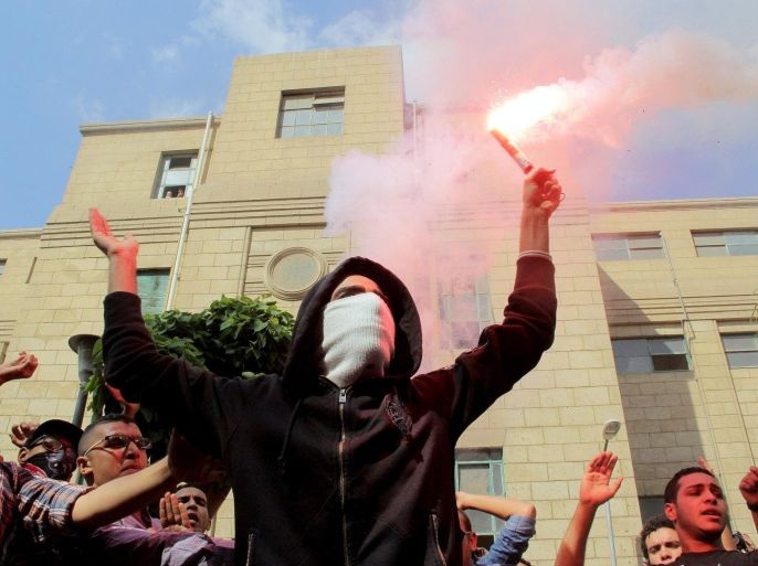 CAIRO, EGYPT - OCTOBER 20: A group of anti-coup Egyptian students gathered outside the Cairo University chant slogans during a protest in Cairo, Egypt, on October 20, 2014.