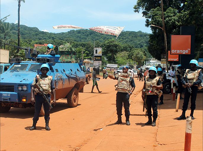 United Nations peacekeepers are seen stationed in the center of the Central African Republic capital Bangui, on October 8, 2014, following fresh violence that rocked the country leaving up to five people dead and several others wounded. The violence was sparked by an incident the day before when a motorcyclist threw grenades injuring several pedestrians in the capital, an officer from the UN peacekeeping MINUSCA force said. Further violence erupted in Bangui's KM5 district when a taxi driver was killed by Muslims who then torched several homes. Separately a group of Muslims tried to advance on the capital's northern districts but were arrested by European peacekeepers. The unrest has pitted different groups -- split along religious, ethnic and tribal lines -- against each other. AFP