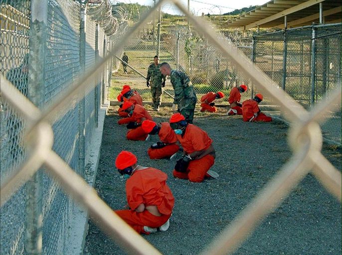 epa02703210 (FILE) A handout photo released 18 January 2002 by the US Department of Defense showing Al-Qaeda and Taliban detainees in orange jumpsuits sitting in a holding area under the surveillance of US military police at Camp X-Ray at Naval Base Guantanamo Bay, Cuba. The 779 prisoners at the US detention facility in Guantanamo, Cuba, included around 30 people suffering from serious mental disorders, the Spanish daily El Pais and other newspapers reported 26 April. El Pais cited US Defence Department documents obtained by WikiLeaks. The WikiLeaks documents give the impression of extremely violent relations between inmates and their guards, El Pais observed. EPA/Shane T. Mccoy/US Department of Defense/HANDOUT HANDOUT EDITORIAL USE ONLY