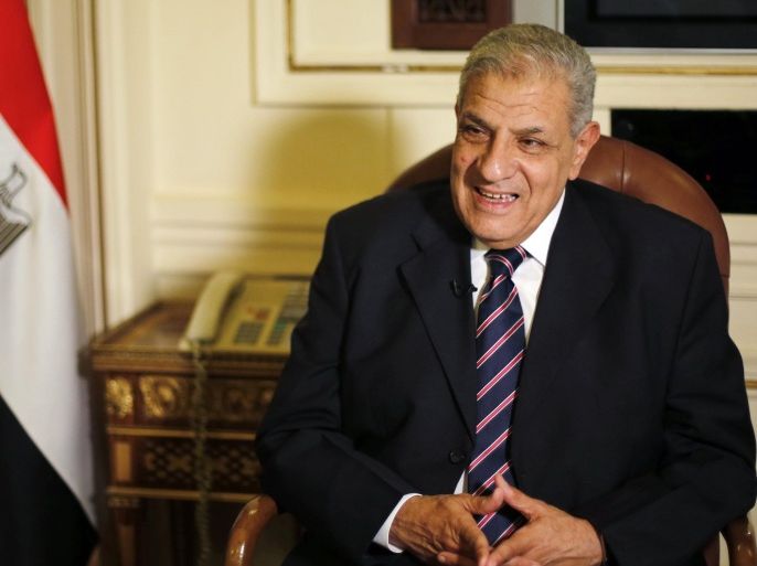 Egypt's Prime Minister Ibrahim Mehleb smiles during an interview with Reuters at his office in the headquarters of the Council of Ministers in Cairo October 19, 2014. Egypt has no plans to provide the U.S. with direct military assistance in its war against Islamic State in Iraq and Syria even though American aerial bombardment may not be enough to defeat the group, Mehleb said. Picture taken October 19. To match Interview MIDEAST-CRISIS/EGYPT REUTERS/Amr Abdallah Dalsh (EGYPT - Tags: POLITICS CONFLICT CIVIL UNREST)