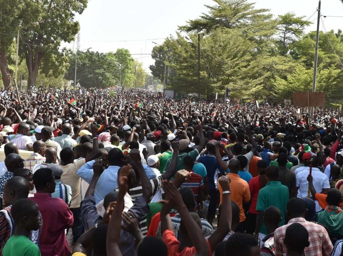 A crowd gathers on October 31, 2014 in front of army headquarters in Ouagadougou, demanding that the army take over following the resignation of the president. Burkina Faso's army chief Navere Honore Traore said he was taking power on October 31 as head of state after President Blaise Compaore announced his resignation as tens of thousands of protesters demanded that he quit immediately after a day of unrest that saw mass protests and the storming of parliament and other public buildings. AFP PHOTO / ISSOUF SANOGO