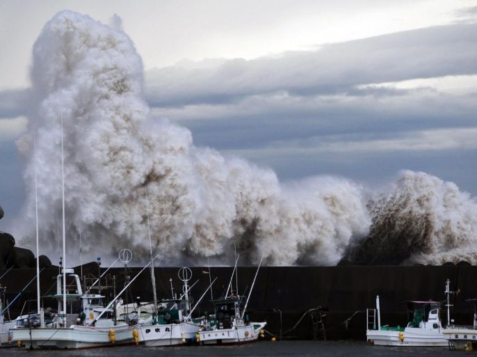 High waves batter a breakwater at a port at Kihou town in Mie prefecture, central Japan on October 6, 2014. Strong typhoon Phanfone slammed into Japan, packing gusts and huge waves that have already swept three US military officials out to sea, as it made a beeline for Tokyo. AFP PHOTO / JIJI PRESS JAPAN OUT
