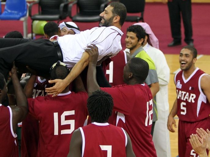 Qatar's coach Qusay Khalaf is carried by members of his team after winning the gold medal of the men's final basketball game against Jordan at the Arab Games in Doha December 22, 2011.