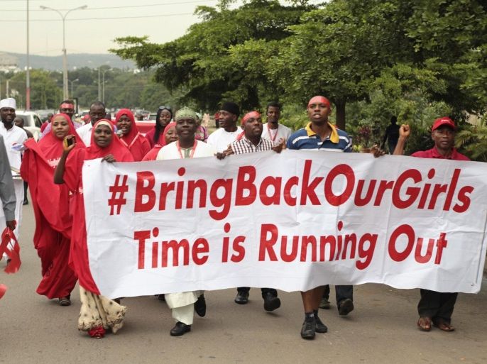Campaigners from "#Bring Back Our Girls" march during a rally calling for the release of the Abuja school girls who were abducted by Boko Haram militants, in Abuja October 17, 2014. Nigeria said on Friday it had agreed a ceasefire with Islamist militants Boko Haram and reached a deal for the release of more than 200 schoolgirls kidnapped by the group six months ago. REUTERS/Afolabi Sotunde (NIGERIA - Tags: CIVIL UNREST POLITICS)