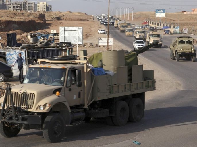 A convoy of Kurdish peshmerga fighters drive through Arbil after leaving a base in northern Iraq, on their way to the Syrian town of Kobani ,October 28, 2014. Iraqi peshmerga fighters left Iraq for the besieged Syrian town of Kobani on Tuesday to help fellow Kurds in their battle against Islamic State militants, a senior Kurdish official said. REUTERS/Azad Lashkari (IRAQ - Tags: CIVIL UNREST POLITICS MILITARY CONFLICT)